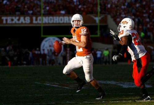 Texas quarterback Colt McCoyl, left, evades Oklahoma State safety Andre Sexton during the fourth quarter of an NCAA college football game, Saturday, Oct. 25, 2008, in Austin, Texas. Texas won 28-24.(AP)